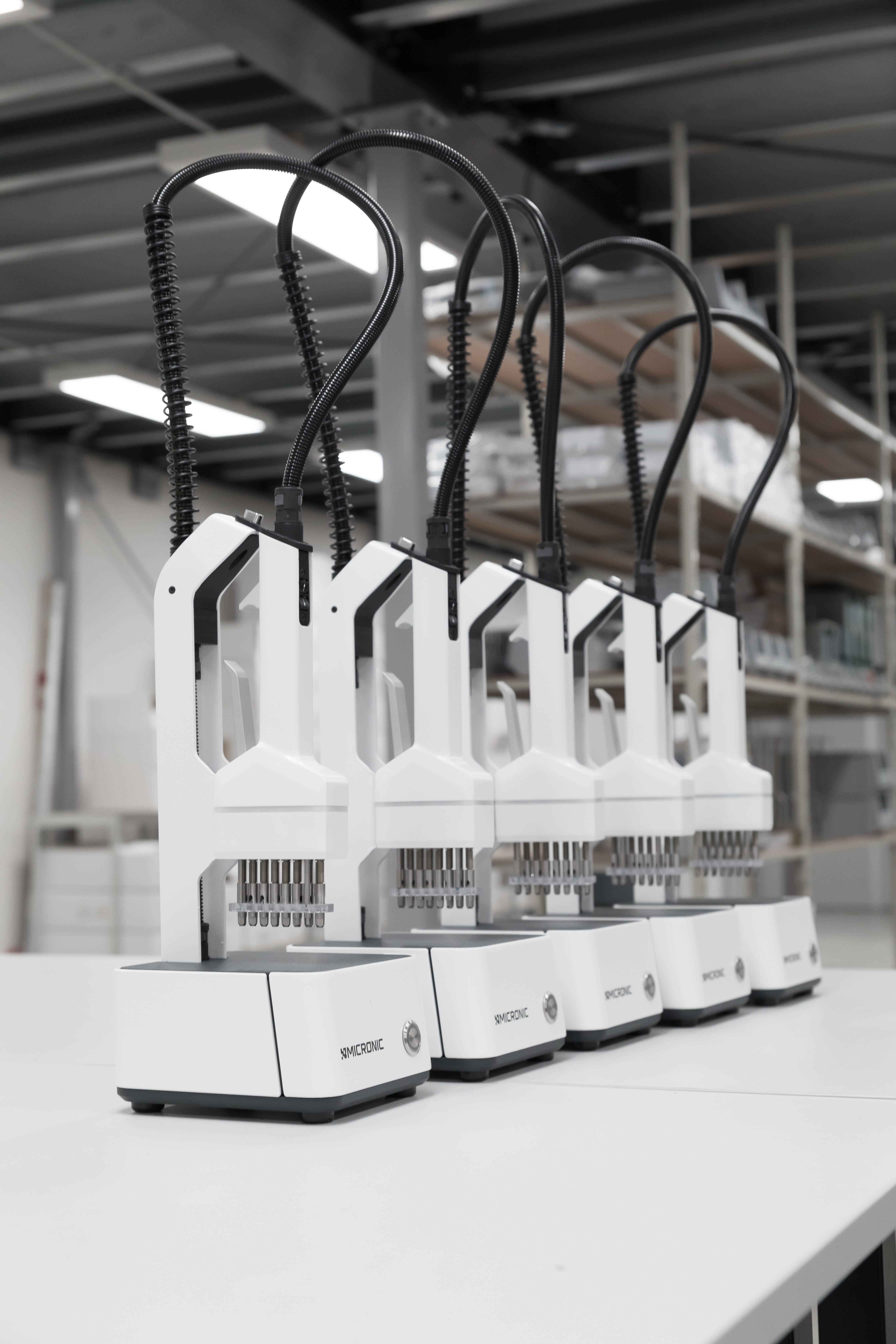 A row of CS500 screw cap recappers by Micronic