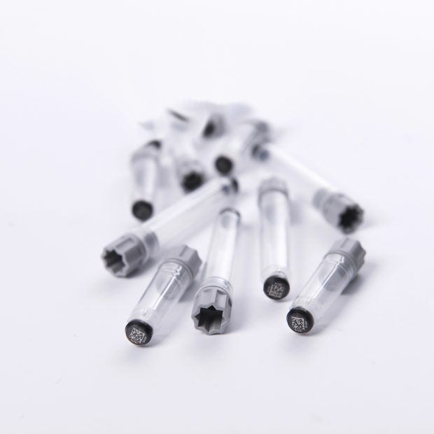 A pile of screw cap tubes precapped with grey screw caps with 2D Data-Matrix codes
