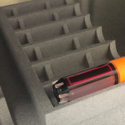 A tube filled with a blood sample inside the Lambda8 information marking system by AFYS3G