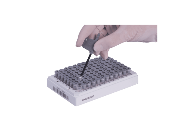 The Micronic low profile screw cap remover being used to (de)cap an internally threaded grey screw cap tube