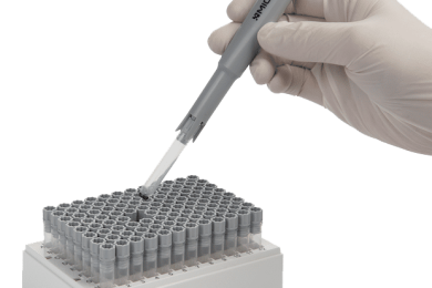 The Micronic tube selector being used to pick an internally threaded tube precapped with a grey screw cap from a rack